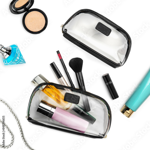 Two clear beauty pouches with blank labels and variety of makeup items, cosmetics and designer perfume bottle laid out on white background. Stylish accessories for beauty enthusiasts