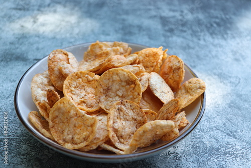 Brown rice chips with spices and salt in bowl