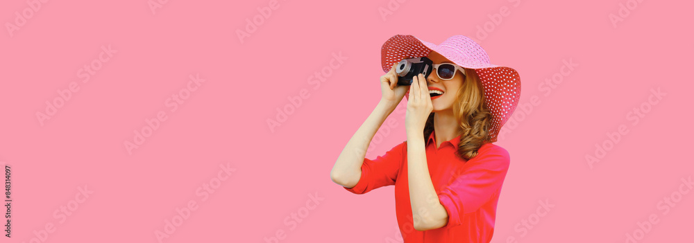 Portrait happy smiling young woman photographer with film camera in summer hat on pink background Portrait happy smiling young woman photographer with film camera in summer hat on pink background