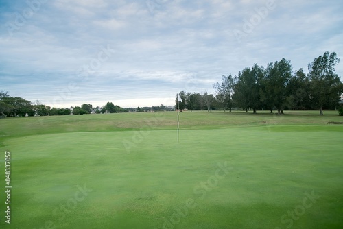 Empty golf course and white flag.