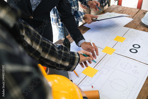engineering is currently discussing structural design issues with architects to review plans to suit construction and stability of building. concept joint consultation between engineers and architects photo