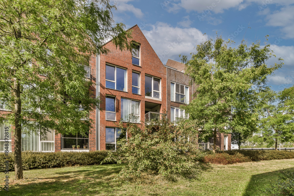 Modern residential building surrounded by lush greenery in Spoorlaan, Netherlands Modern residential building surrounded by lush greenery in Spoorlaan, Netherlands