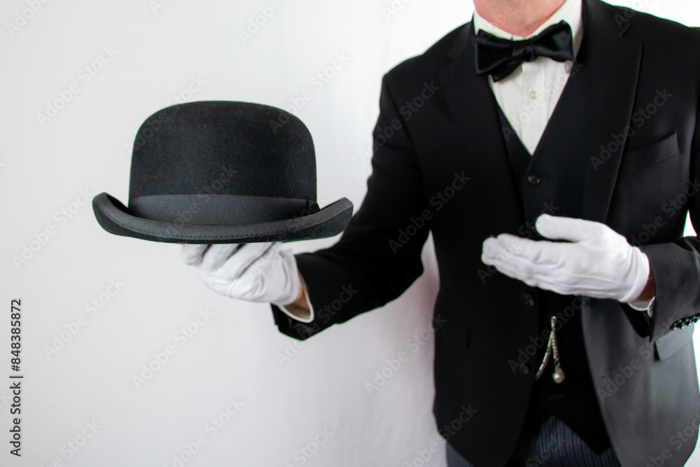 Portrait of Butler or Waiter in Formal Suit and White Gloves Holding Bowler Hat. Service Industry and Professional Hospitality. Portrait of Butler or Waiter in Formal Suit and White Gloves Holding Bowler Hat. Service Industry and Professional Hospitality.