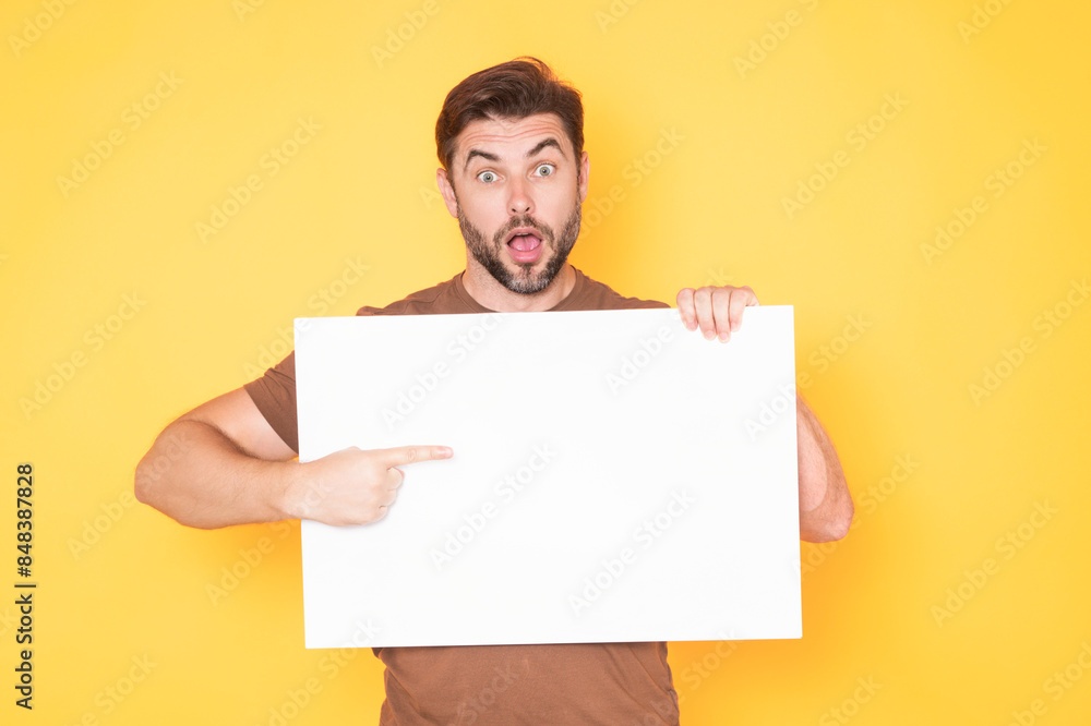 Middle aged man with blank placard. Demonstrating copy space for your text or design. Man showing empty advertisement board on studio background. Blank placard, signboard for ad. Middle aged man with blank placard. Demonstrating copy space for your text or design. Man showing empty advertisement board on studio background. Blank placard, signboard for ad.