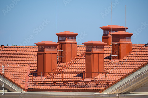 house with a roof from a red shingles with a pipe