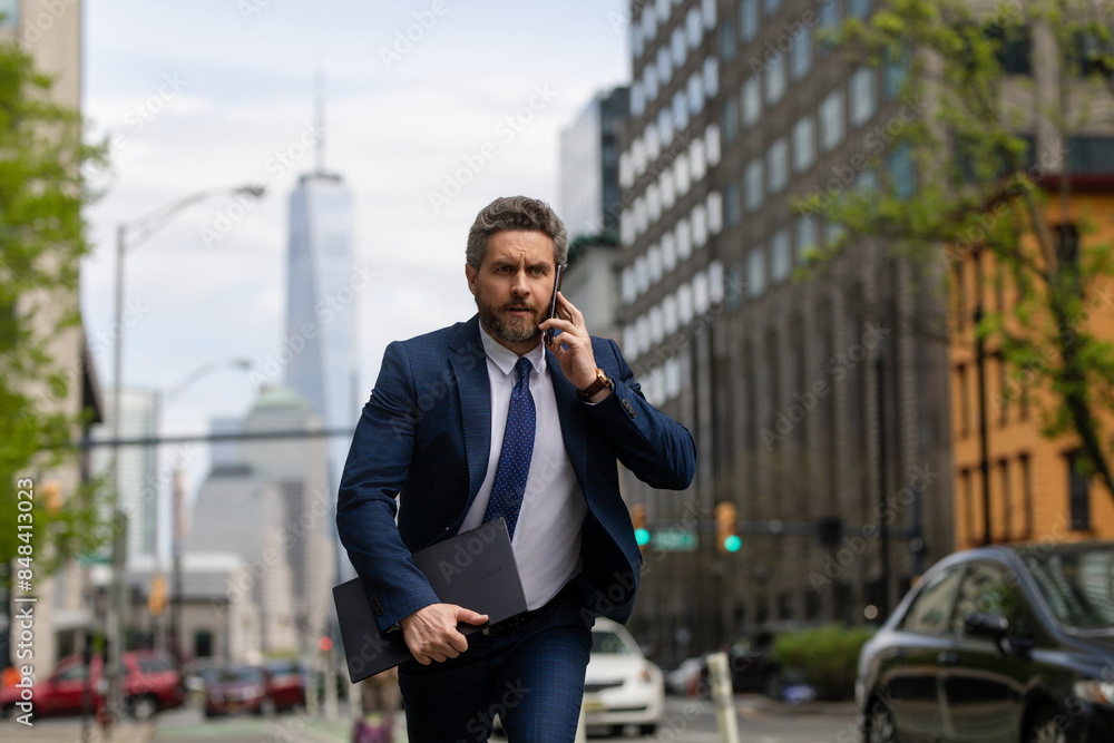 Businessman with phone run in NY. Business talk. Businessman run down street talking on the phone. Man in suit late. Business call. Running business man. Fast business. Run and late businessman. Businessman with phone run in NY. Business talk. Businessman run down street talking on the phone. Man in suit late. Business call. Running business man. Fast business. Run and late businessman.