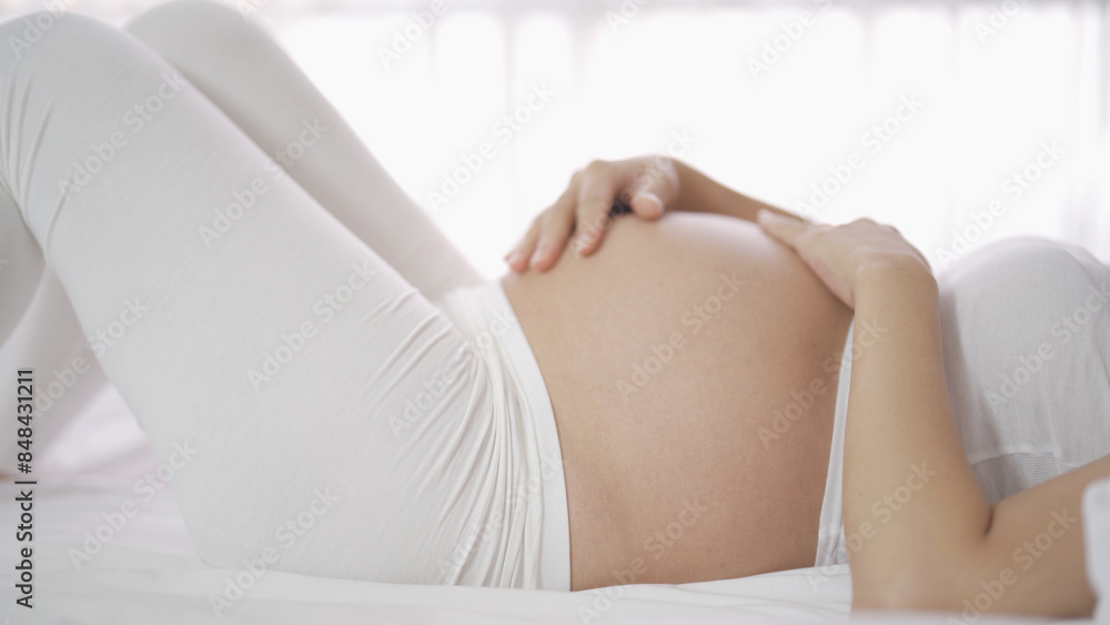 Close up of a Portrait of happy pregnant woman in bedroom at home. Having a baby. Family people lifestyle. Mom love. Close up of a Portrait of happy pregnant woman in bedroom at home. Having a baby. Family people lifestyle. Mom love.