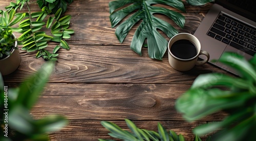 A Laptop, Coffee, and Greenery on a Wooden Table