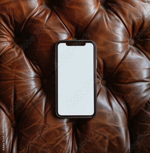 Modern Smartphone Laying on a Brown Leather Couch
