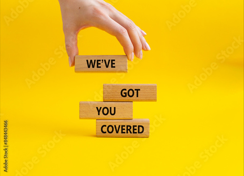 We have got you covered symbol. Concept words We have got you covered blocks. Beautiful yellow background. Businessman hand. Business and We have got you covered concept. Copy space. photo