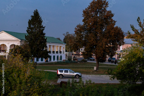 A white Lada Largus station wagon on a city street at dusk in Suzdal photo