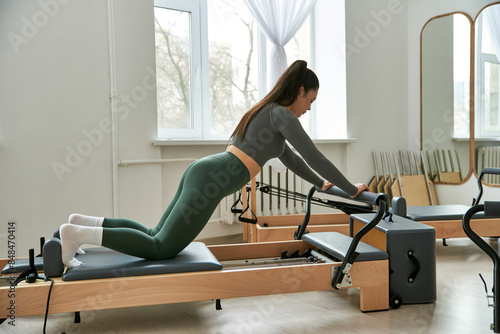 A woman in motion, executing flawless exercises. photo