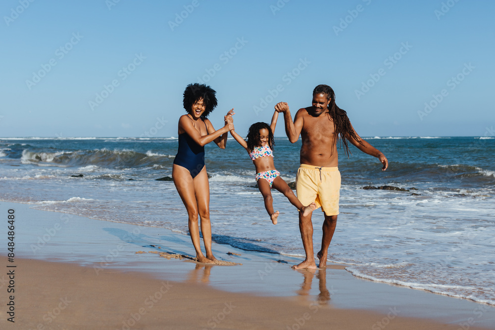 Happy family enjoying beach vacation on a warm summer day Happy family enjoying beach vacation on a warm summer day