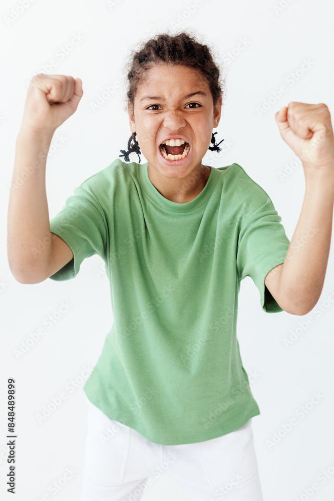 empowered young boy in vibrant outfit raises fists in celebration of success and confidence empowered young boy in vibrant outfit raises fists in celebration of success and confidence