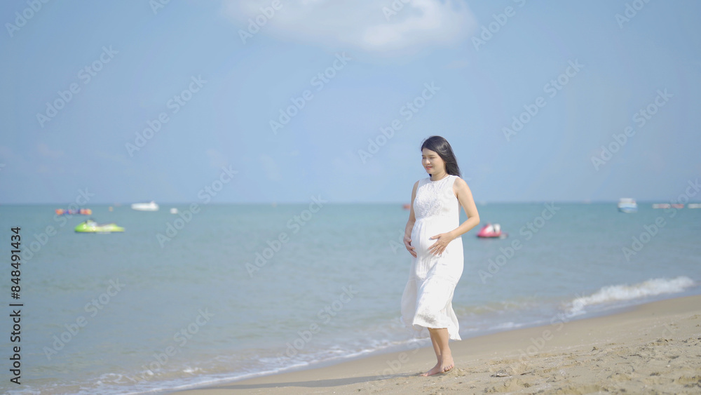 A portrait of happy Asian pregnant woman at sea shore beach. Having a baby. Family people lifestyle. Mom love. A portrait of happy Asian pregnant woman at sea shore beach. Having a baby. Family people lifestyle. Mom love.