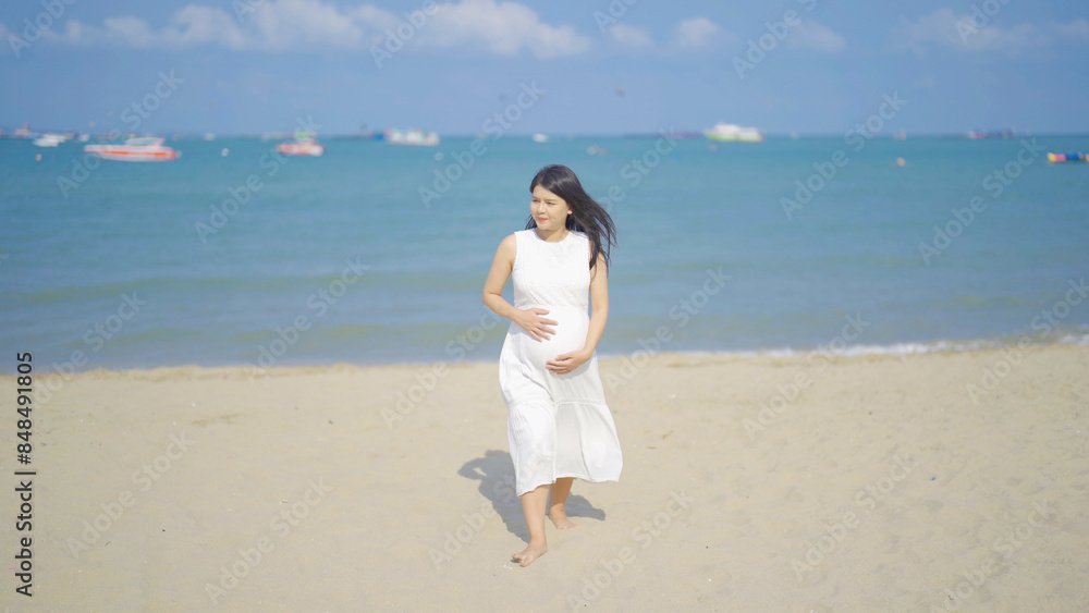A portrait of happy Asian pregnant woman at sea shore beach. Having a baby. Family people lifestyle. Mom love. A portrait of happy Asian pregnant woman at sea shore beach. Having a baby. Family people lifestyle. Mom love.