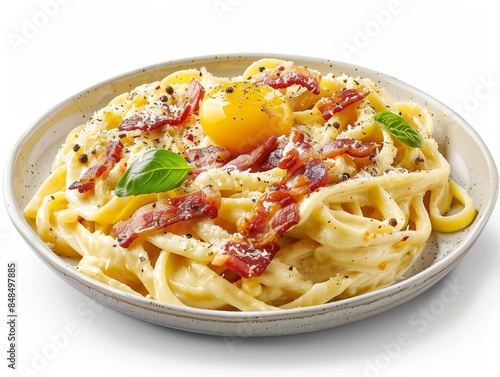 A serving of carbonara featuring fettuccine noodles, white background