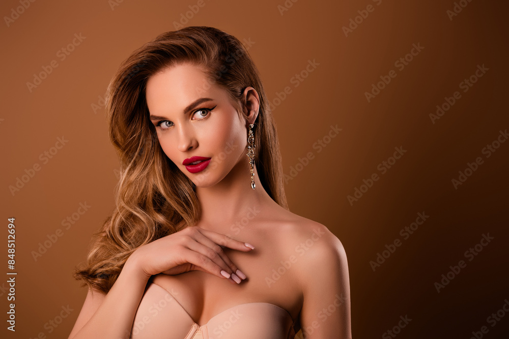 Portrait of stunning young model girl empty space ad bare shoulders isolated on beige color background Portrait of stunning young model girl empty space ad bare shoulders isolated on beige color background