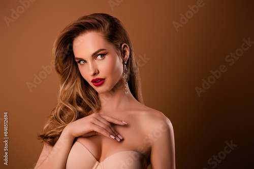 Portrait of stunning young model girl empty space ad bare shoulders isolated on beige color background
