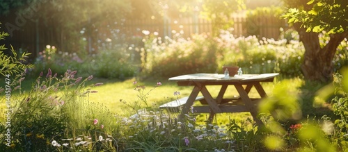 Product placement opportunity in a sunlit summer garden with an empty table as the focal point photo