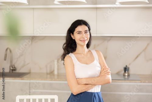 Portrait of housewife standing at home kitchen © JackF