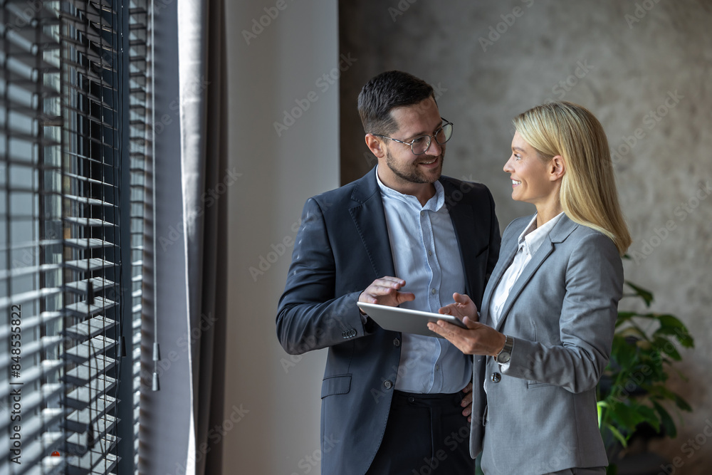 Woman and man discussing business ideas with digital laptop in office Woman and man discussing business ideas with digital laptop in office