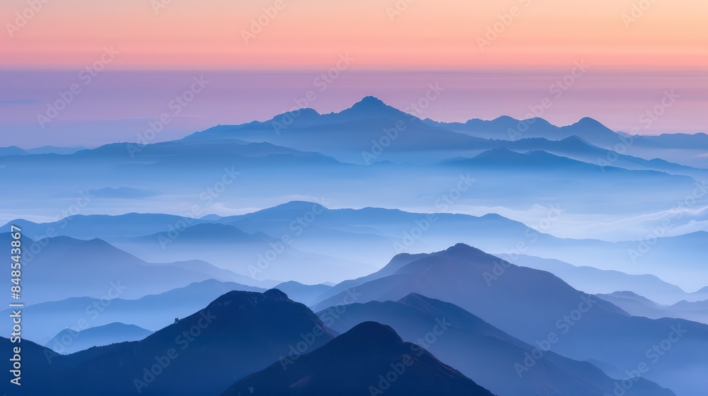 Fototapeta premium beauty of mountain ranges layered in shades of blue and purple, basked in the warm glow of sunrise