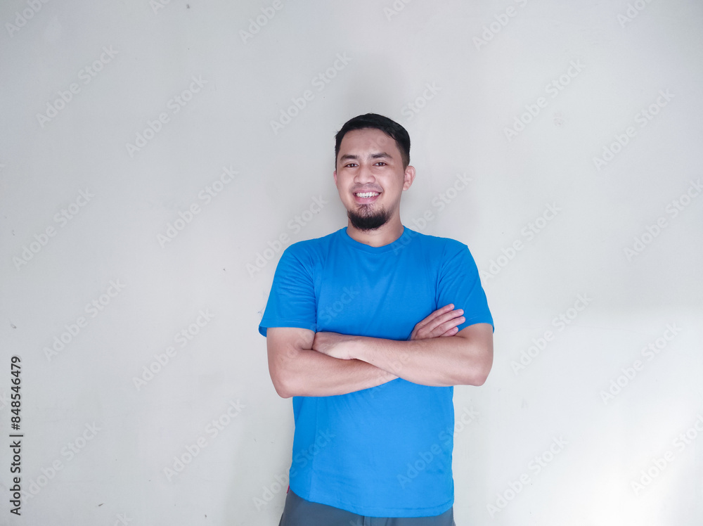 Adult Asian man hugging his self with happy face expression Adult Asian man hugging his self with happy face expression