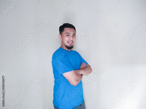 Adult Asian man hugging his self with happy face expression photo