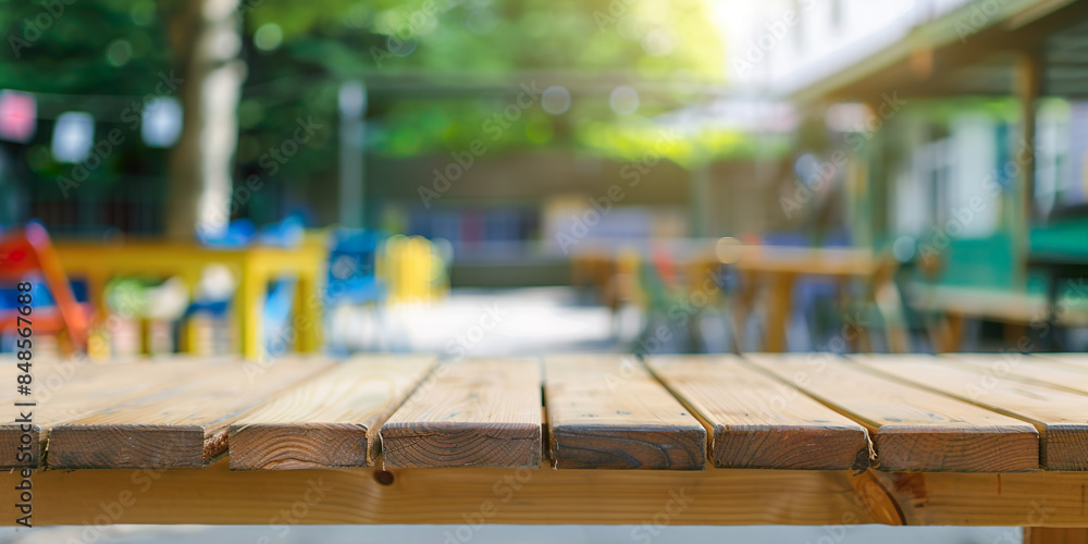 Wooden table, kingdergarden background, with colored tables outside Wooden table, kingdergarden background, with colored tables outside