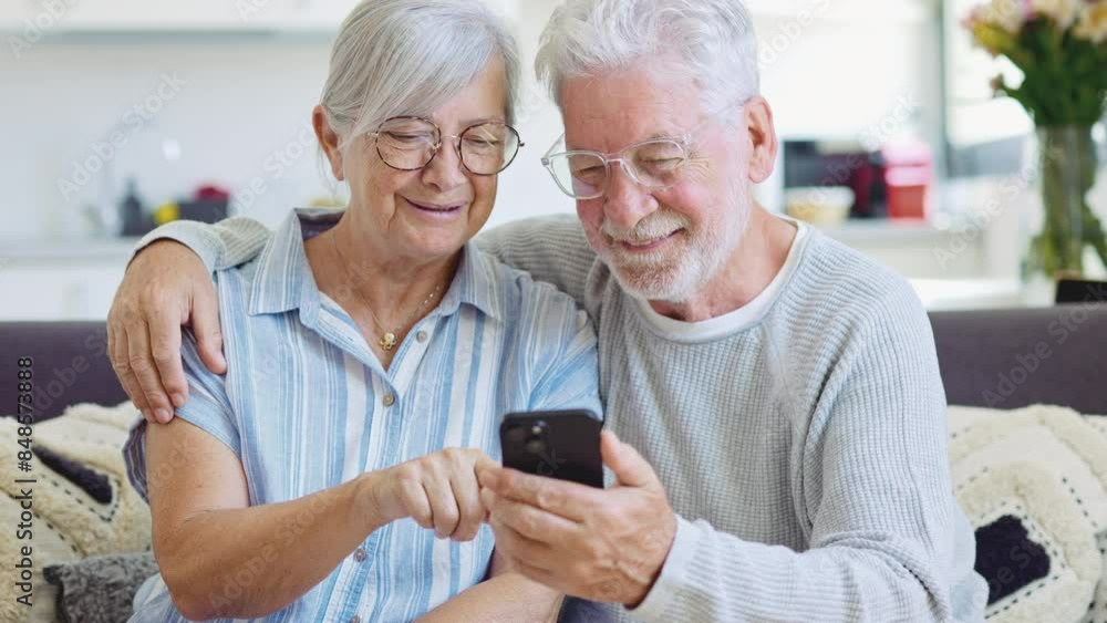 Happy mature family, wife and husband using phone together at home, smiling middle aged man and woman sitting on couch, using mobile device apps, watching video in social network, surfing internet
Happy mature family, wife and husband using phone together at home, smiling middle aged man and woman sitting on couch, using mobile device apps, watching video in social network, surfing internet
