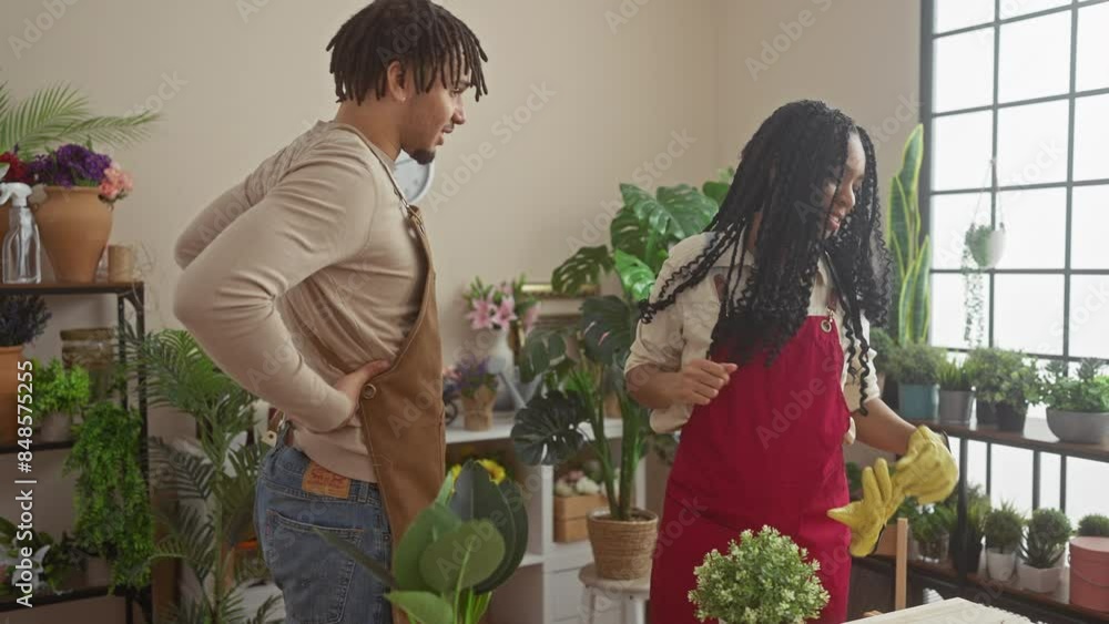 A woman and a man engaging in a playful conversation in a vibrant flower shop surrounded by various potted plants and floral arrangements. A woman and a man engaging in a playful conversation in a vibrant flower shop surrounded by various potted plants and floral arrangements.