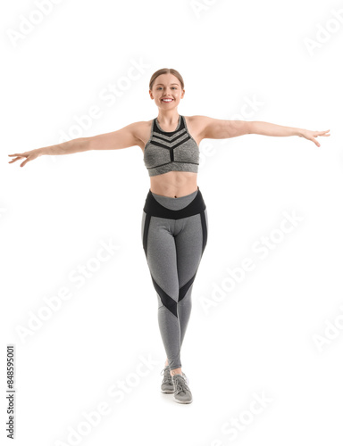 Sporty young woman balancin...