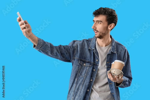 Handsome young man with cup...