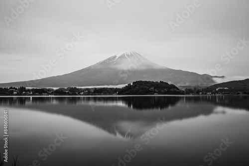 Black and white picture of mount Fuji under clouds with relection in a lake photo