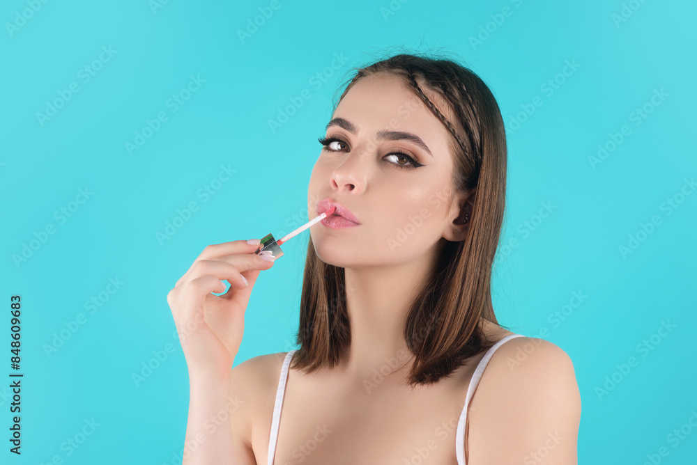Sexy girl use lipstick, background beauty and fashion, lips appreciation concept. Plump woman lips, isolated on blue studio background. Sexy girl use lipstick, background beauty and fashion, lips appreciation concept. Plump woman lips, isolated on blue studio background.