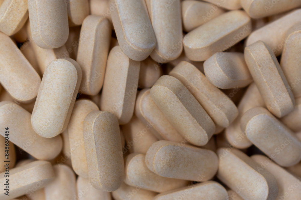 Top view of yellow pharmaceutical pills, vitamins, antibiotics, medicines manufactured according to the formulation and dosage form, pharmaceutical concept, close up, background Top view of yellow pharmaceutical pills, vitamins, antibiotics, medicines manufactured according to the formulation and dosage form, pharmaceutical concept, close up, background