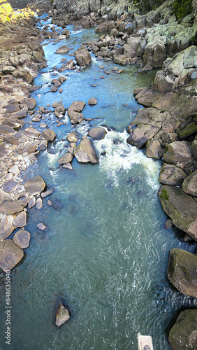 The South Esk River, shallow in its course, cascades over a bed of moss-covered igneous dolerite rock, creating a sequence of cataracts. photo