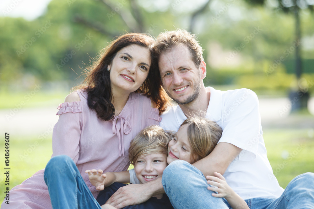 Caucasian family parent and their children picnic at the park in morning. Caucasian family parent and their children picnic at the park in morning.
