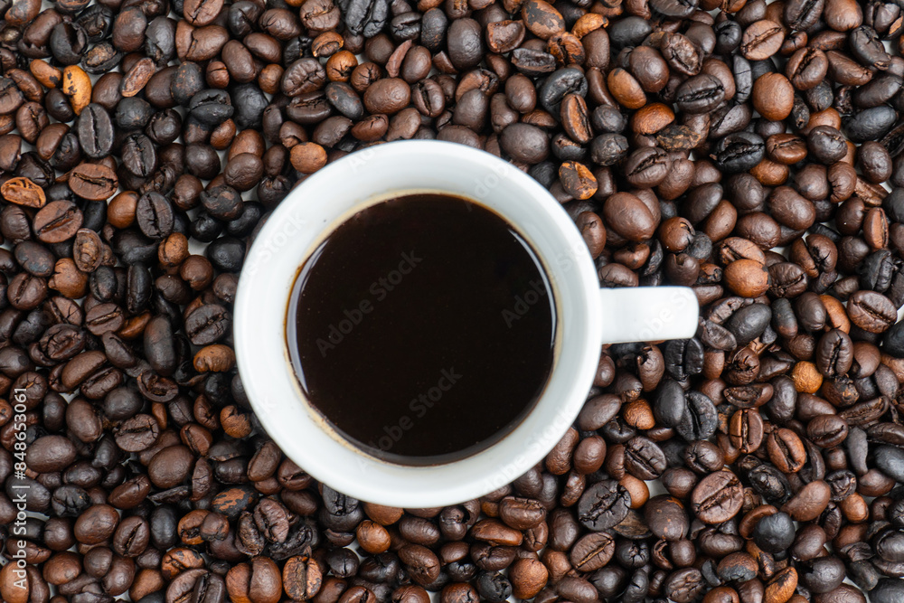 top view of a cup of coffee in the middle of a coffee pile top view of a cup of coffee in the middle of a coffee pile