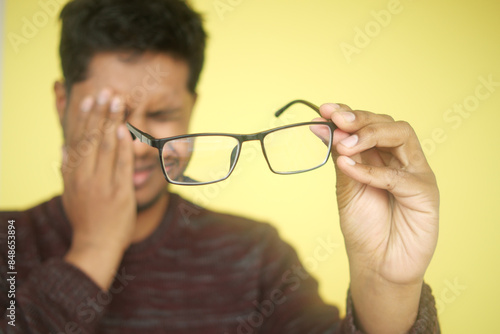  upset man suffering from strong eye pain