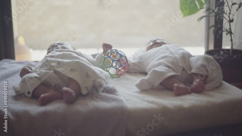 Everyday life of twin children lying on the futon and enjoying toy photo