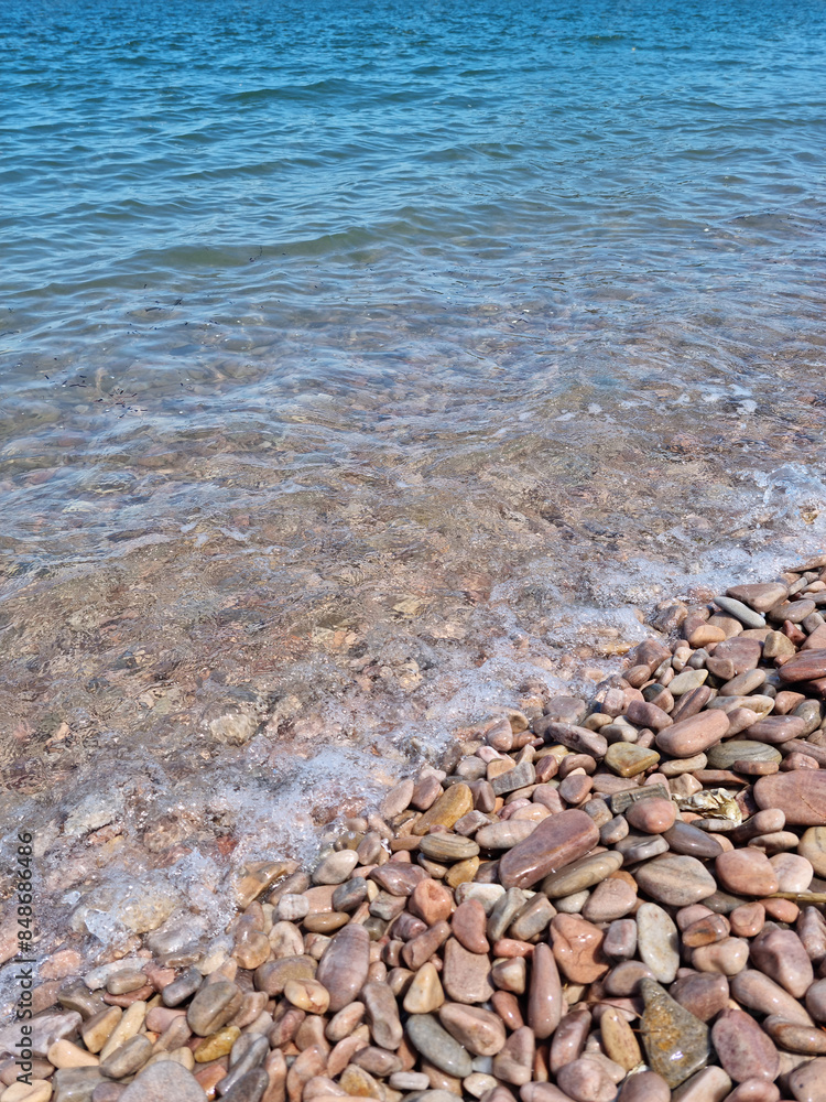 It is a beach with round pebbles.
It is a beach with round pebbles.