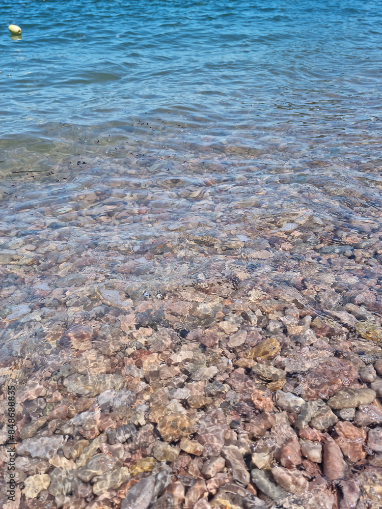 It is a beach with round pebbles.
It is a beach with round pebbles.