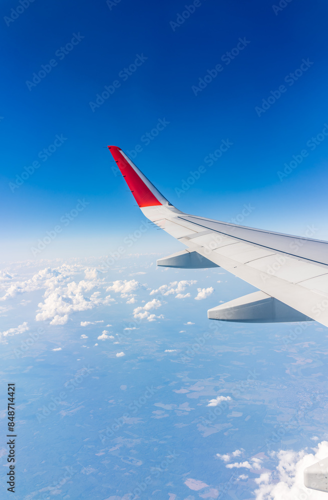 View from the airplane window at a beautiful cloudy sky and the airplane wing View from the airplane window at a beautiful cloudy sky and the airplane wing