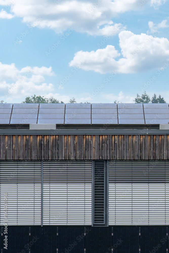 The roof of a modern building with eco-friendly solar panels installed on the roof. The roof of a modern building with eco-friendly solar panels installed on the roof.