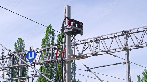 Railway Infrastructure with Truss Mast Catenary Gate and Overhead Power Line Wire Dropper and Insulator photo