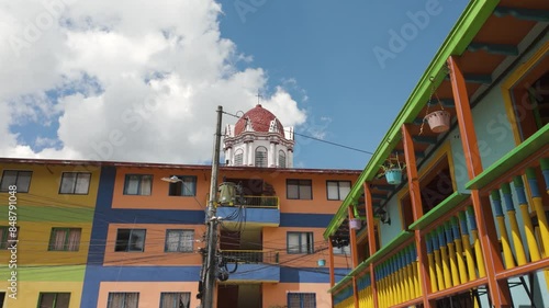 Colorful buildings in Guatapé, Colombia, with umbrellas and vibrant facades photo