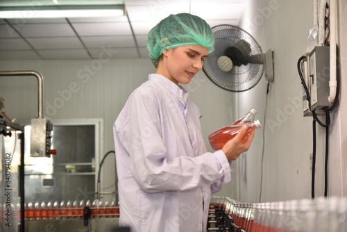 QC manager inspecting the quality of a beverage product in the production process photo