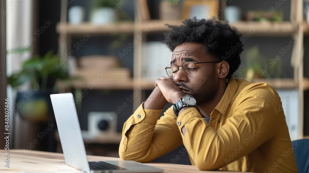 Close-Up of a Frustrated Job Seeker at a Desk with a Laptop, Looking at Job Listings Close-Up of a Frustrated Job Seeker at a Desk with a Laptop, Looking at Job Listings